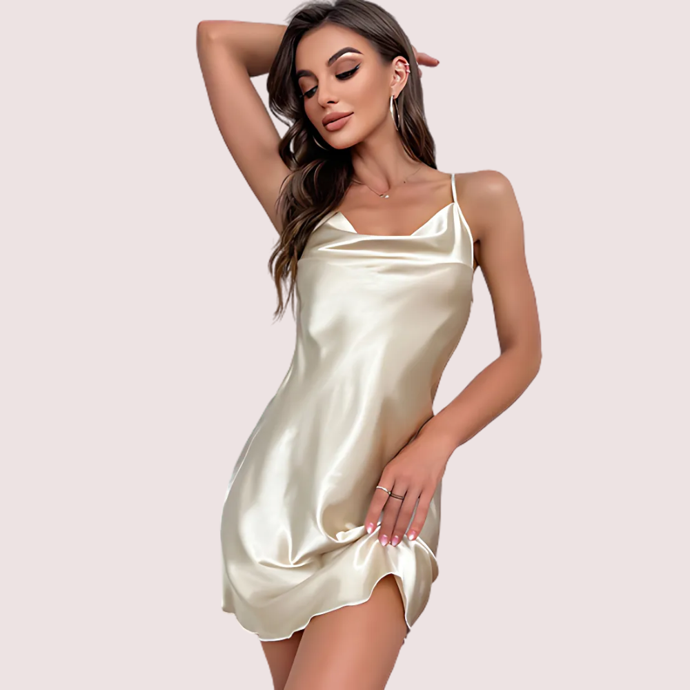 Woman wearing a satin slip dress on a plain background