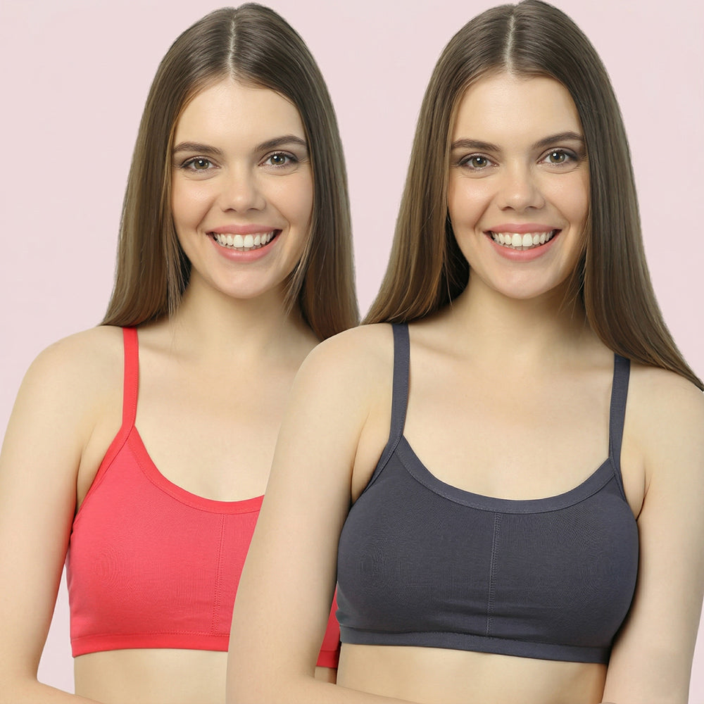 Two women wearing red and gray bras against a pink background