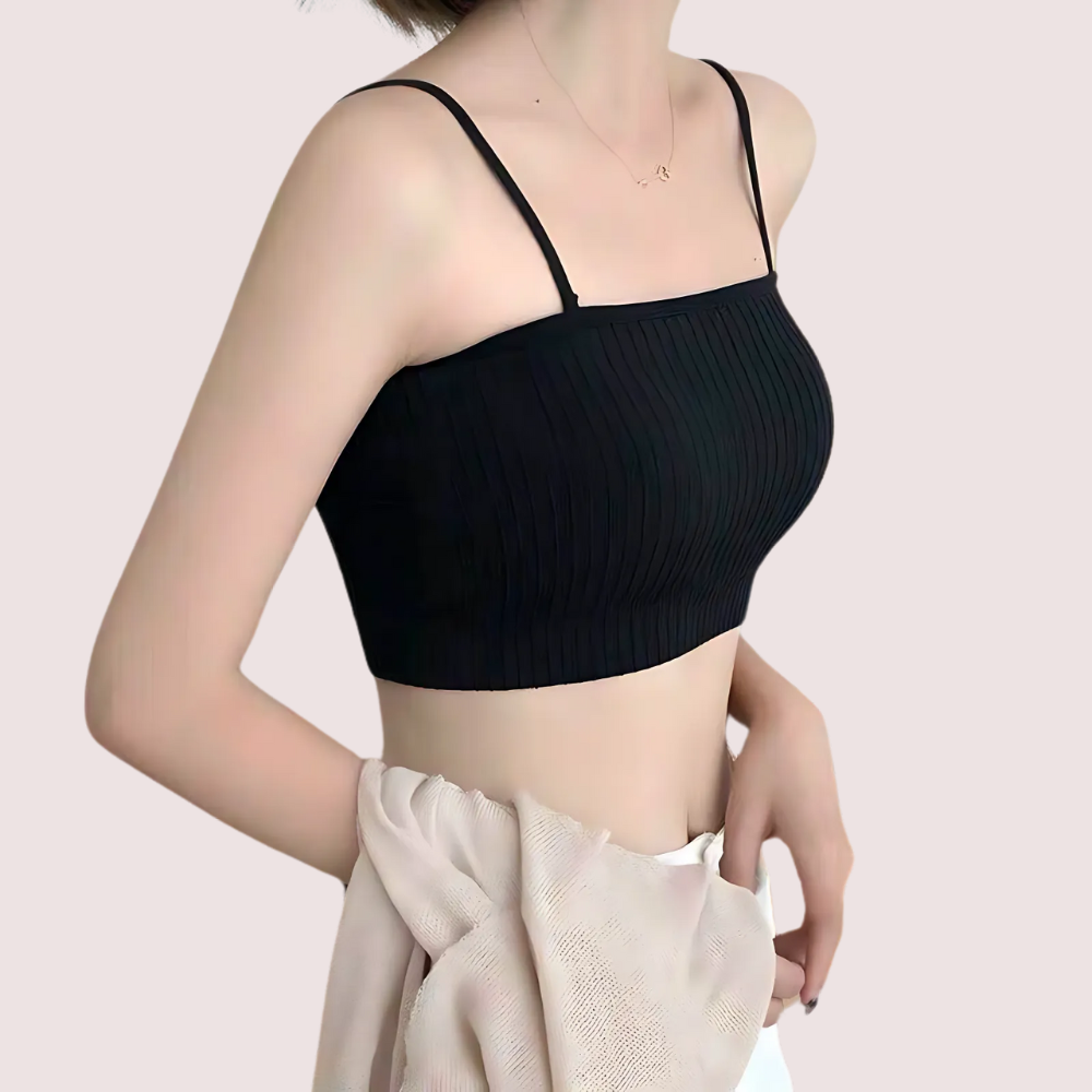 Black ribbed tank top worn by a person on a light pink background