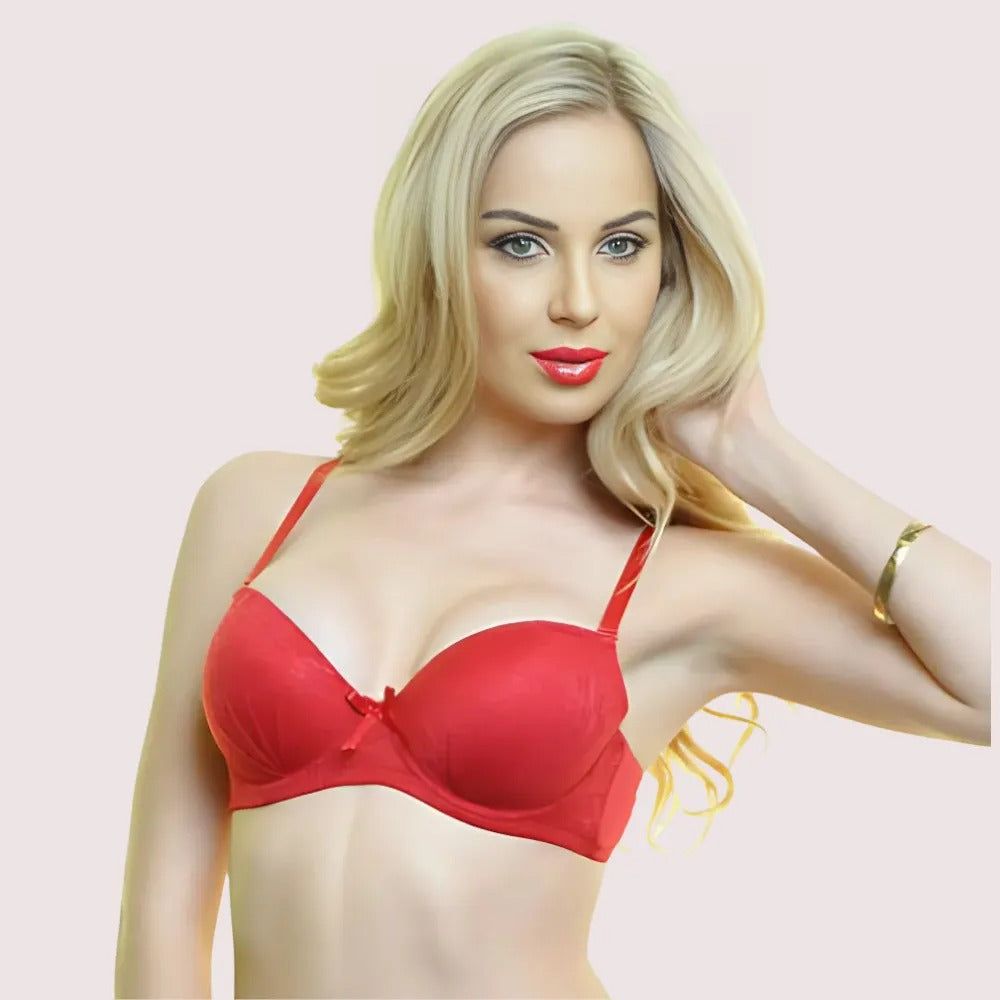 Woman wearing a red bra against a light pink background