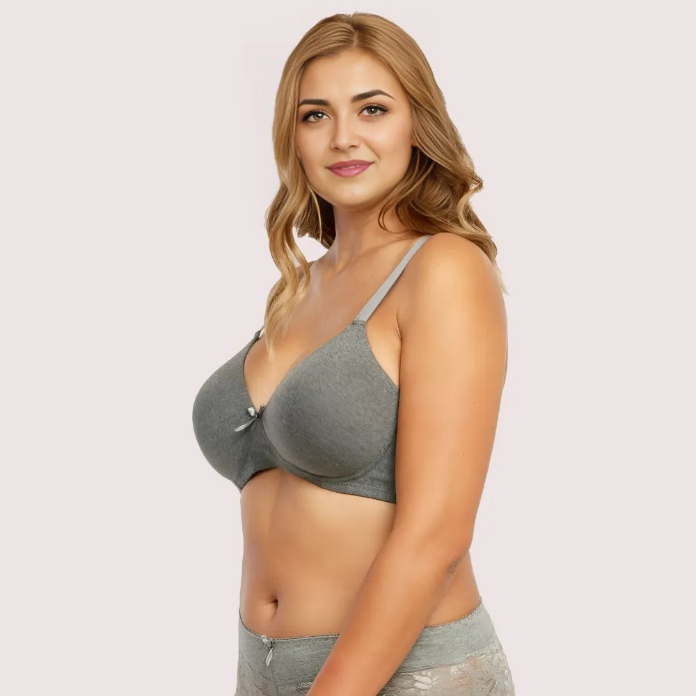 Woman wearing a gray bra and underwear set on a light pink background