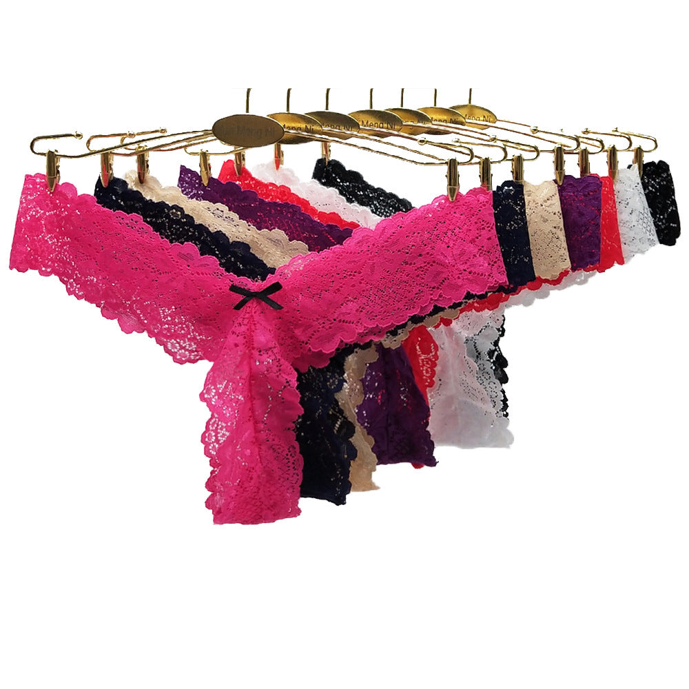 Set of colorful lace panties on a gold hanger against a white background