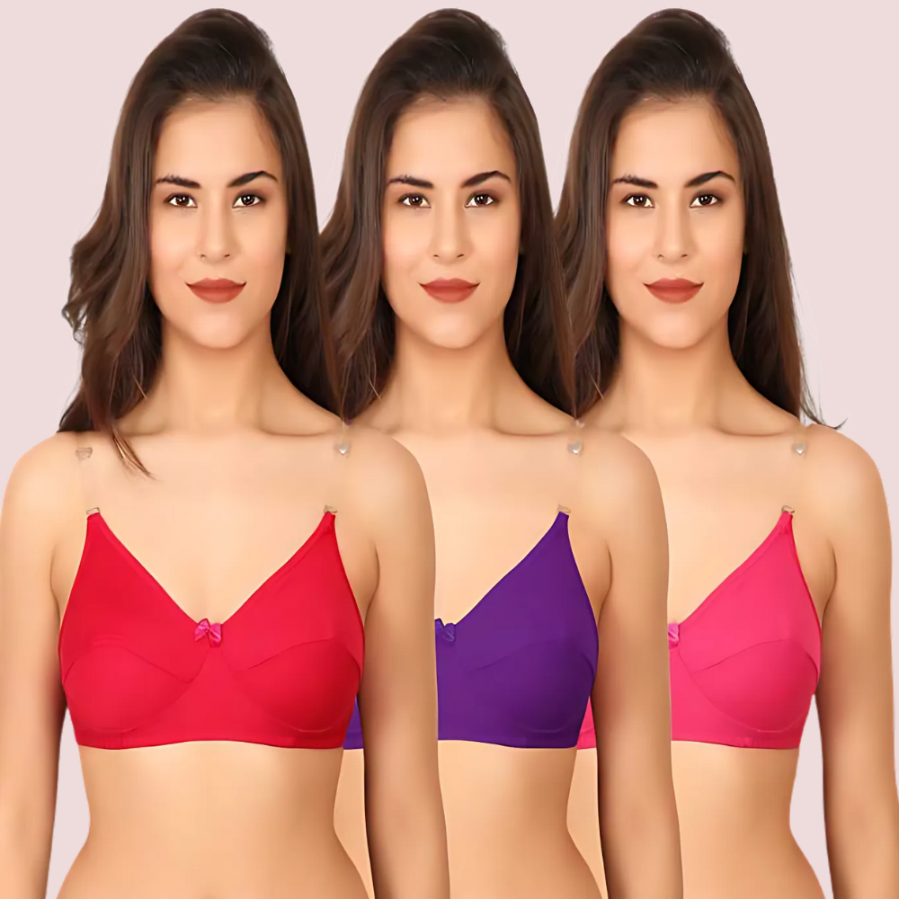 Three women wearing different colored bras on a plain background