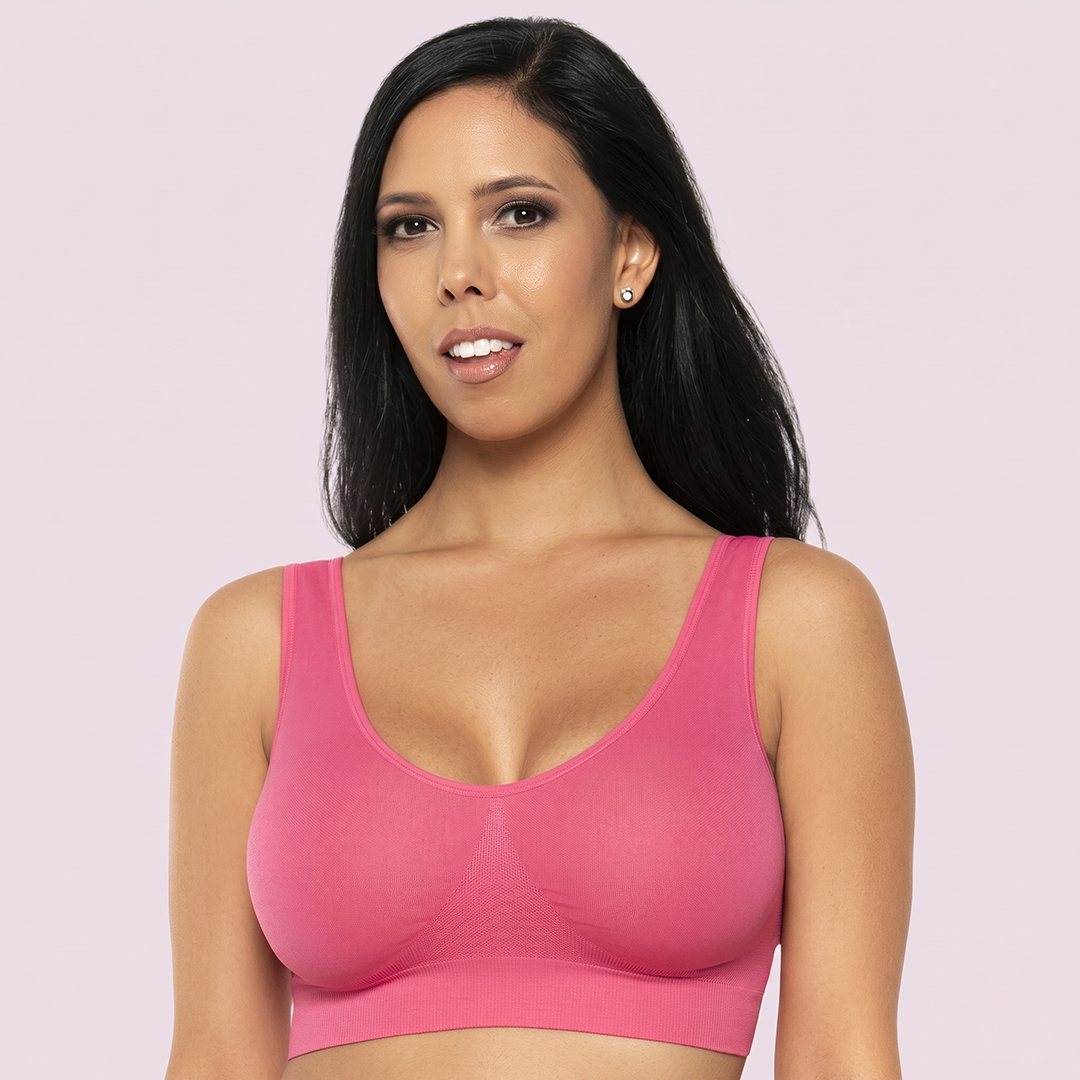 Woman wearing a pink sports bra against a light purple background