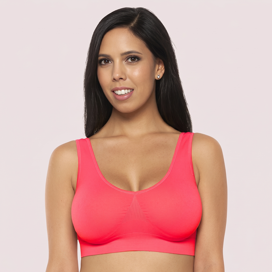 Woman wearing a pink sports bra against a light pink background