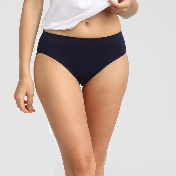 Person wearing navy blue underwear on a plain background