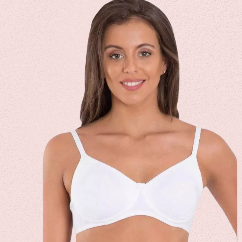 Woman wearing a white bra against a pink background