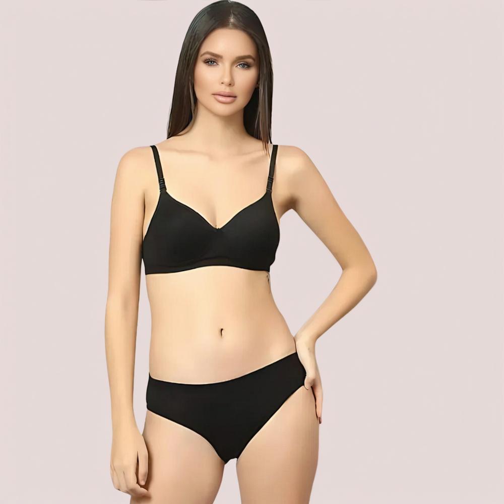 Woman wearing a black bikini set on a plain background