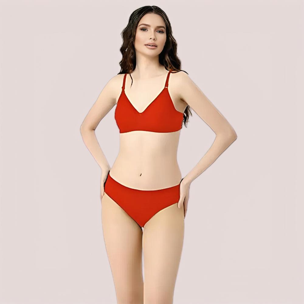 Woman wearing a red bikini set on a plain background