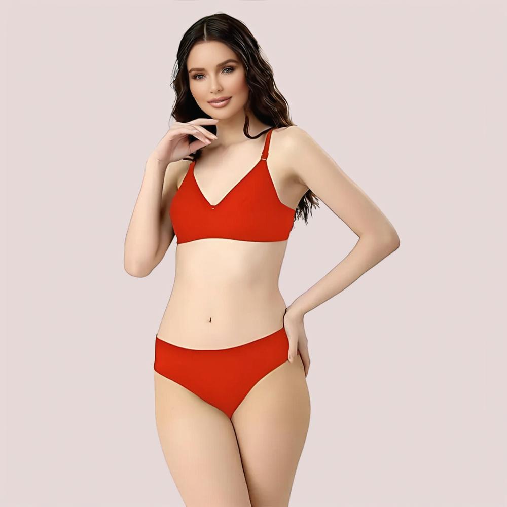 Woman wearing a red bikini set on a light pink background