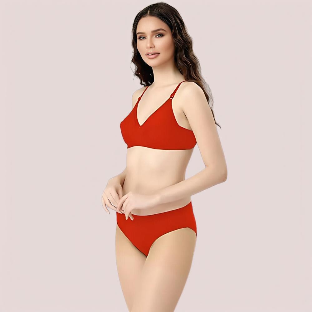 Woman wearing a red bra set on a light pink background