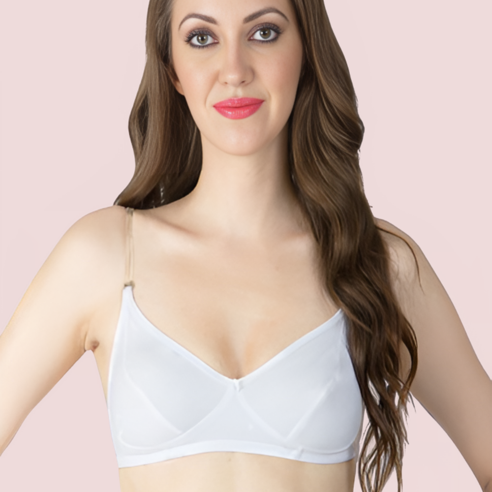 Woman wearing a white bra against a pink background