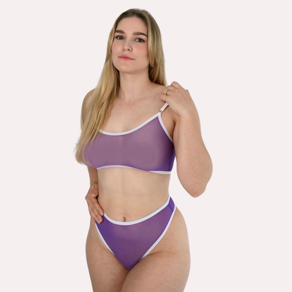 Woman wearing a purple bikini with white straps on a plain background