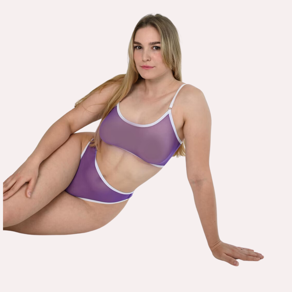 Woman wearing a purple lingerie set on a white background
