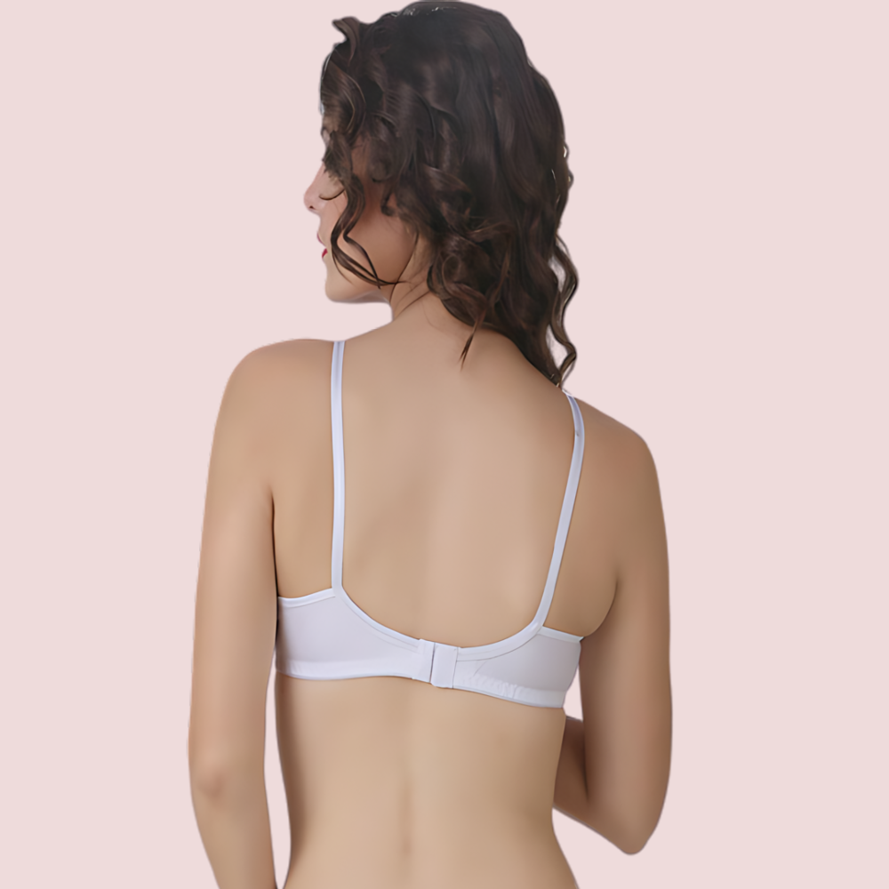 Woman wearing a white bra on a beige background