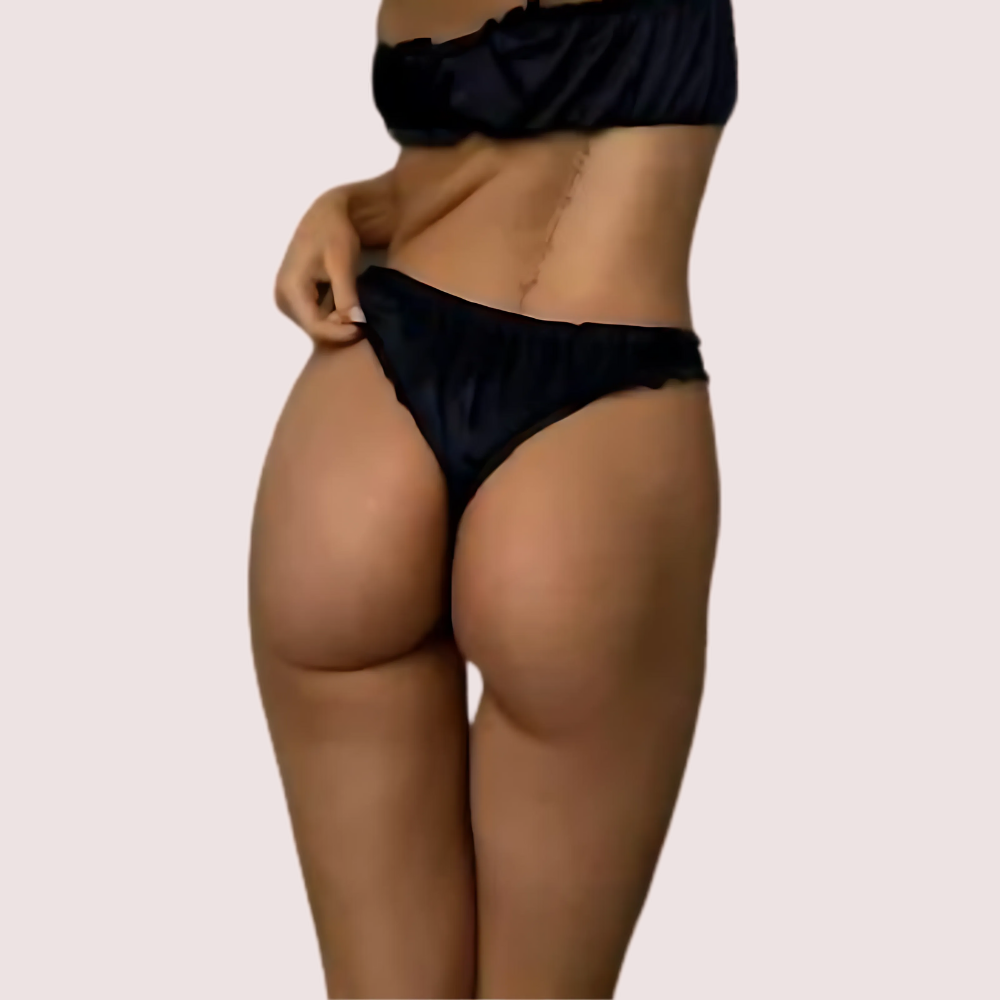 Person wearing a black bikini on a beige background