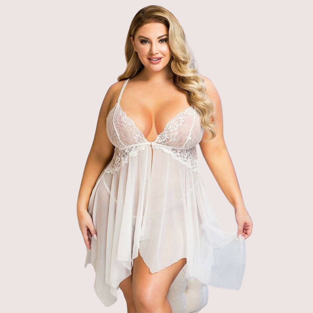 Woman wearing a white lace nightgown against a plain background