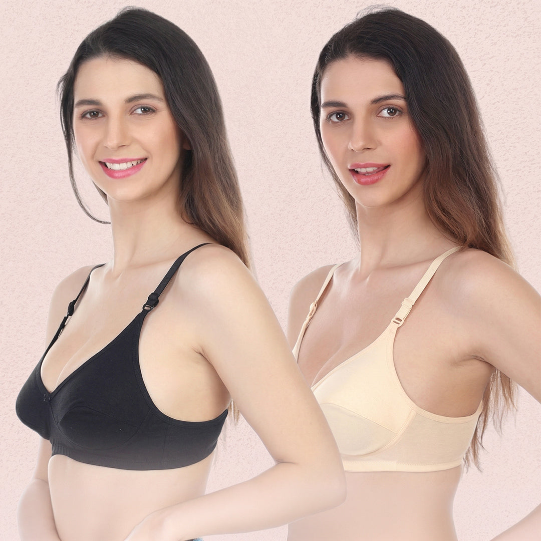 Two women wearing black and beige bras against a light pink background