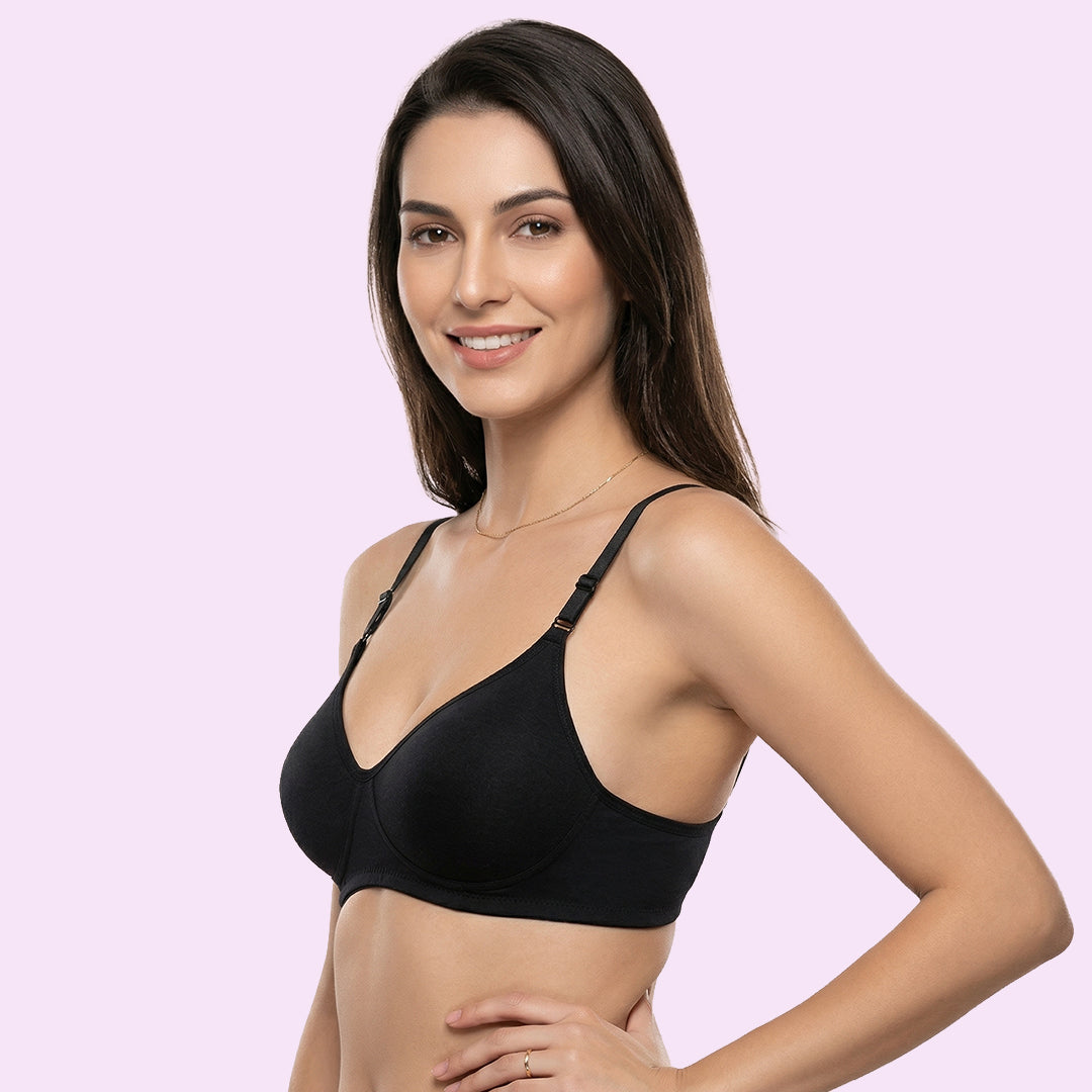 Woman wearing a pink bikini set on a plain background