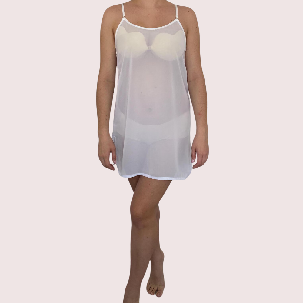 White sheer nightgown worn by a person on a light pink background