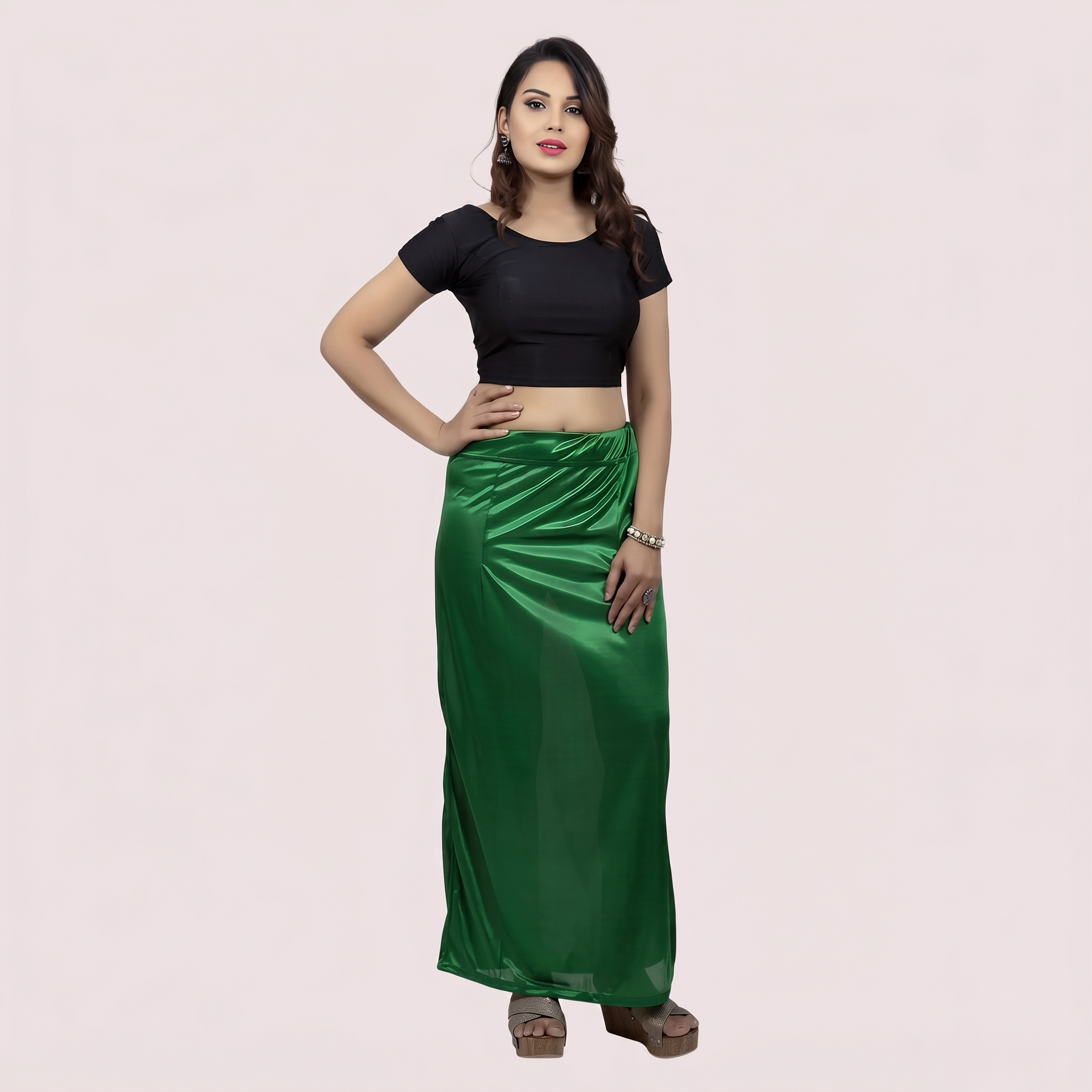 Woman wearing a black top and green under skirt 