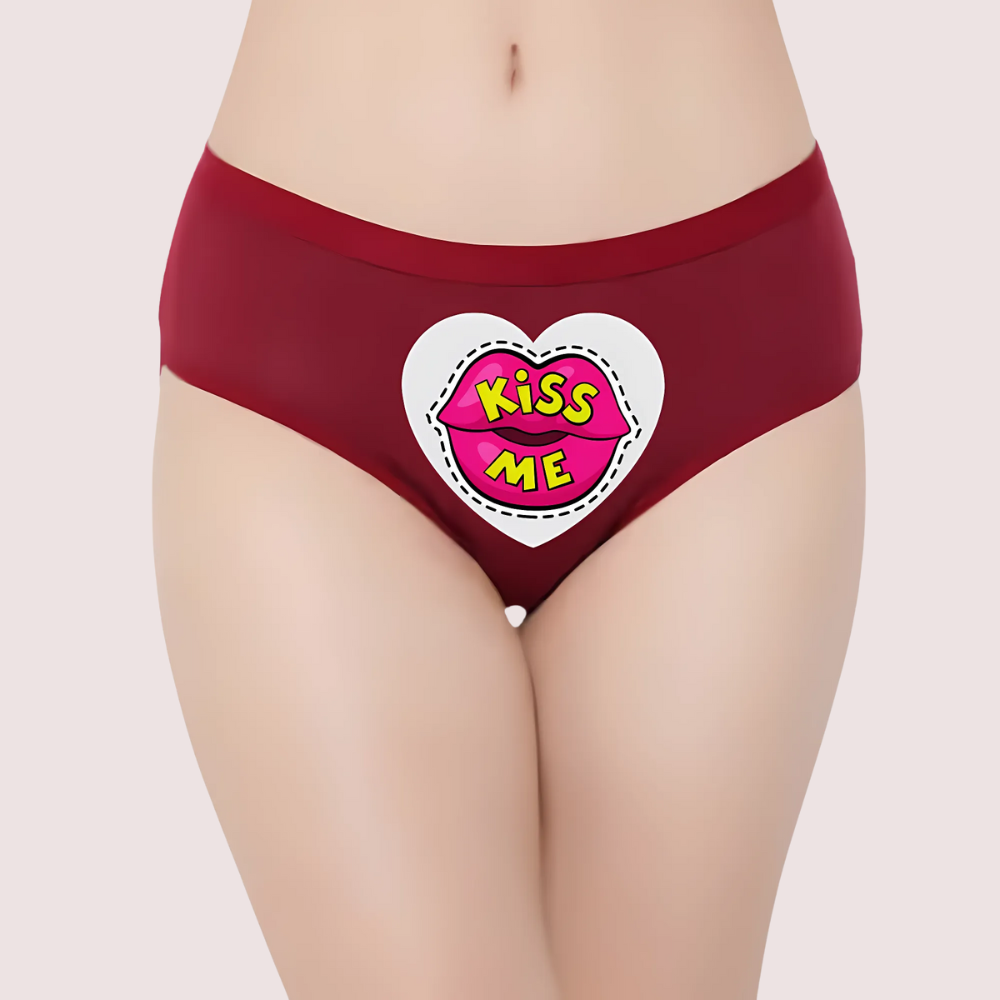 Red underwear with a heart-shaped 'Kiss Me' patch on a light background