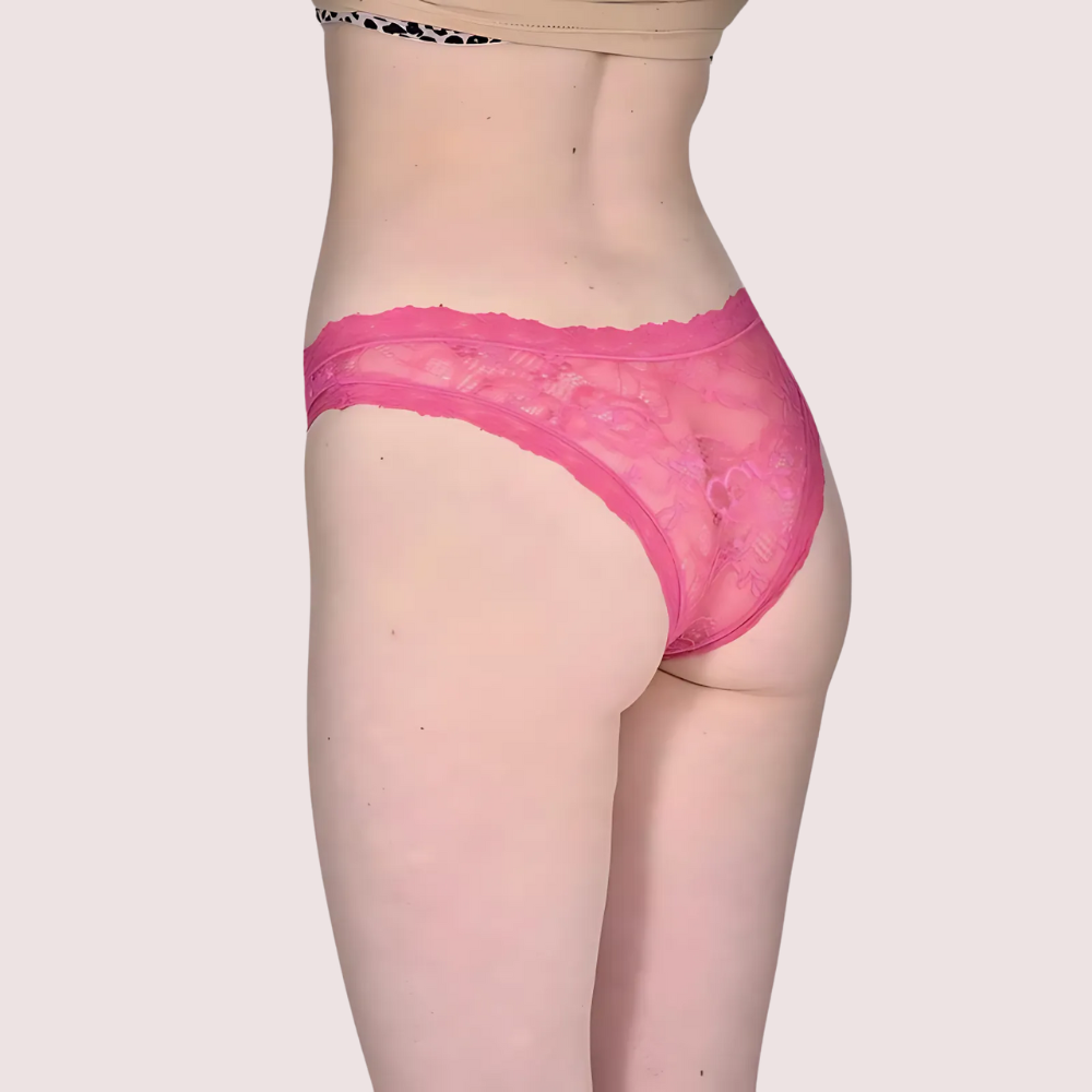 Person wearing pink lace underwear on a plain background
