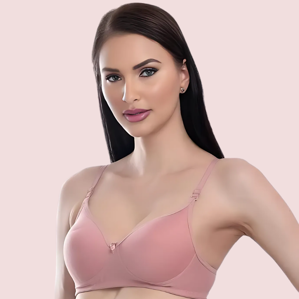 Woman wearing a pink bra against a light pink background