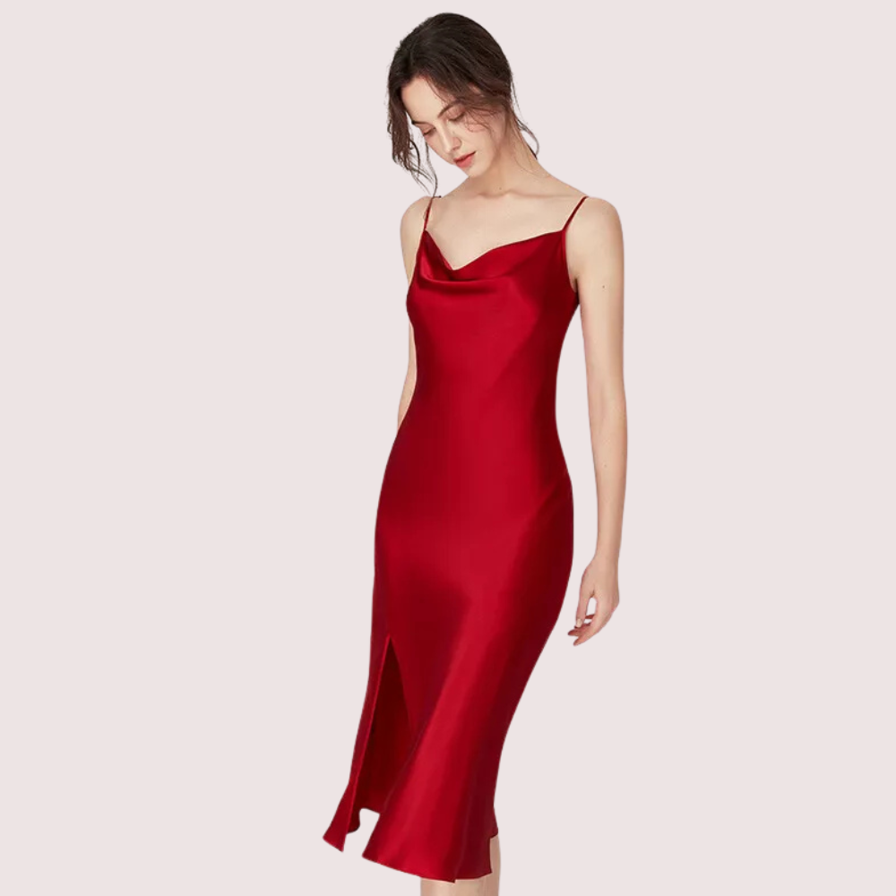 Red slip dress worn by a model on a light pink background