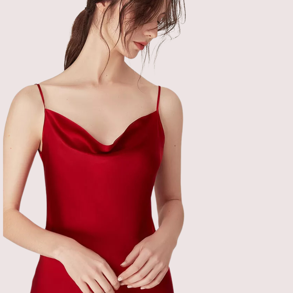 Red dress worn by a model on a light pink background