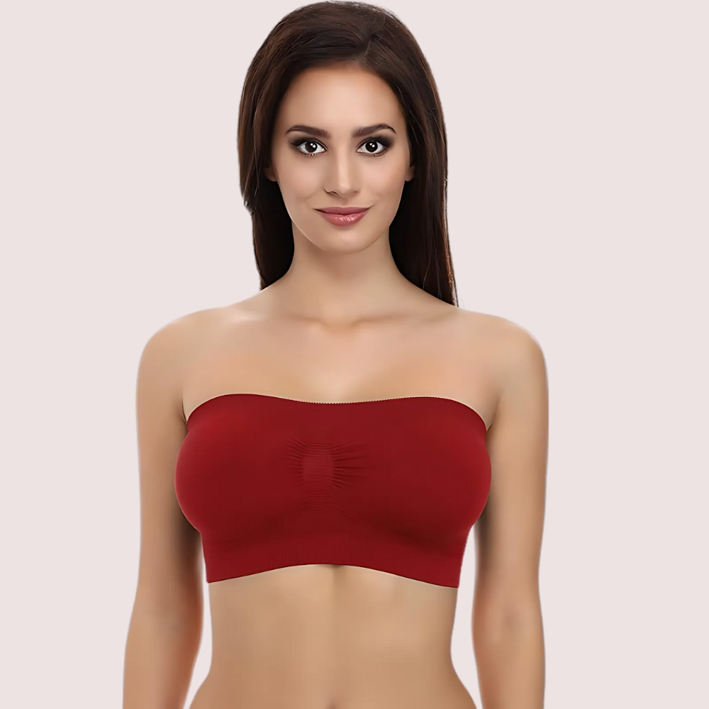 Woman wearing a strapless red top against a plain background