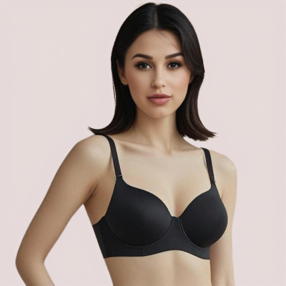 Woman wearing a black bra against a light pink background