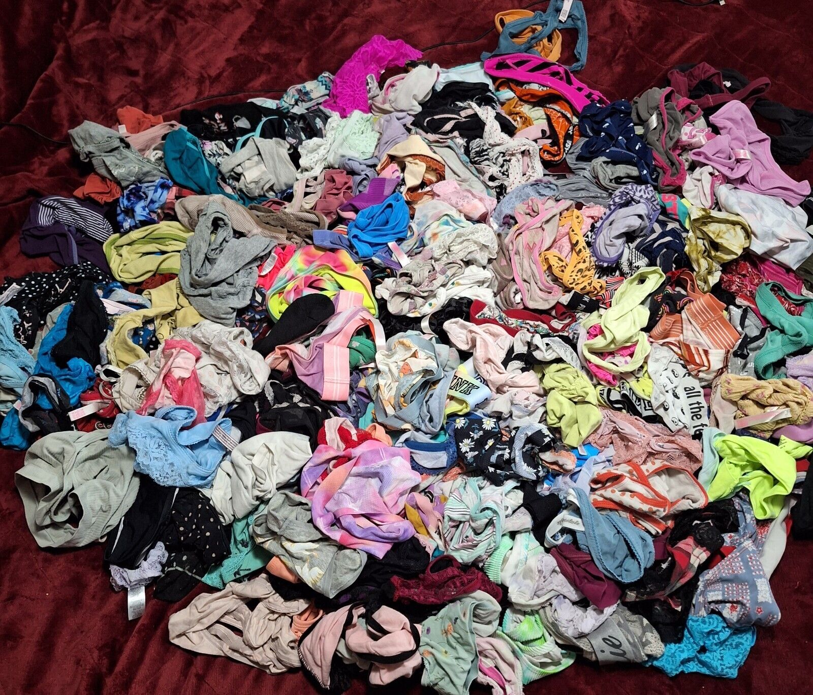 Large pile of colorful scrunchies on a red background