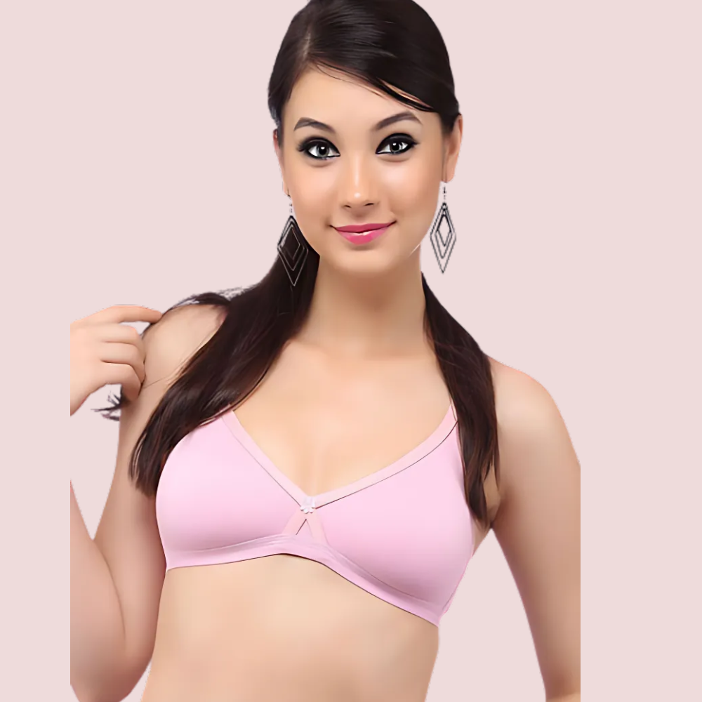 Woman wearing a pink bra against a light pink background
