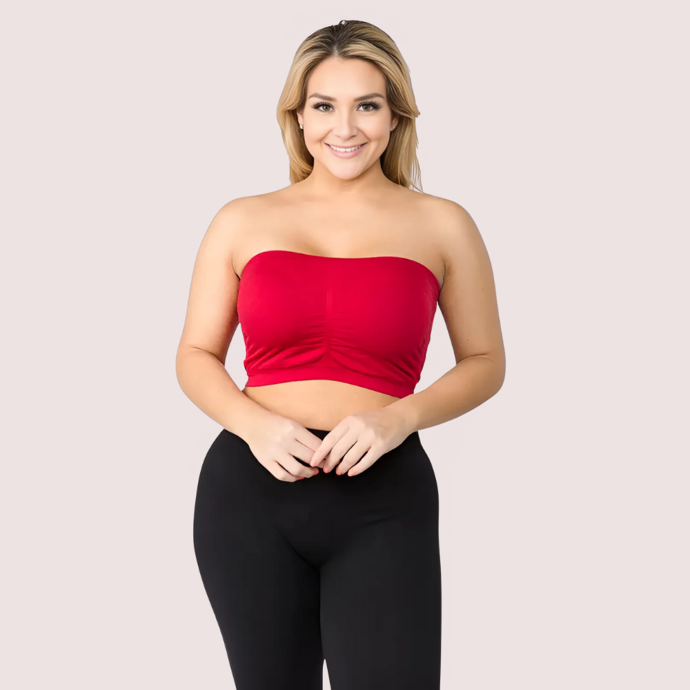 Woman wearing a red strapless top and black leggings on a light gray background