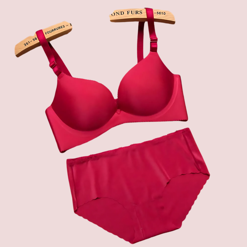 Red bra and panties set on a beige background
