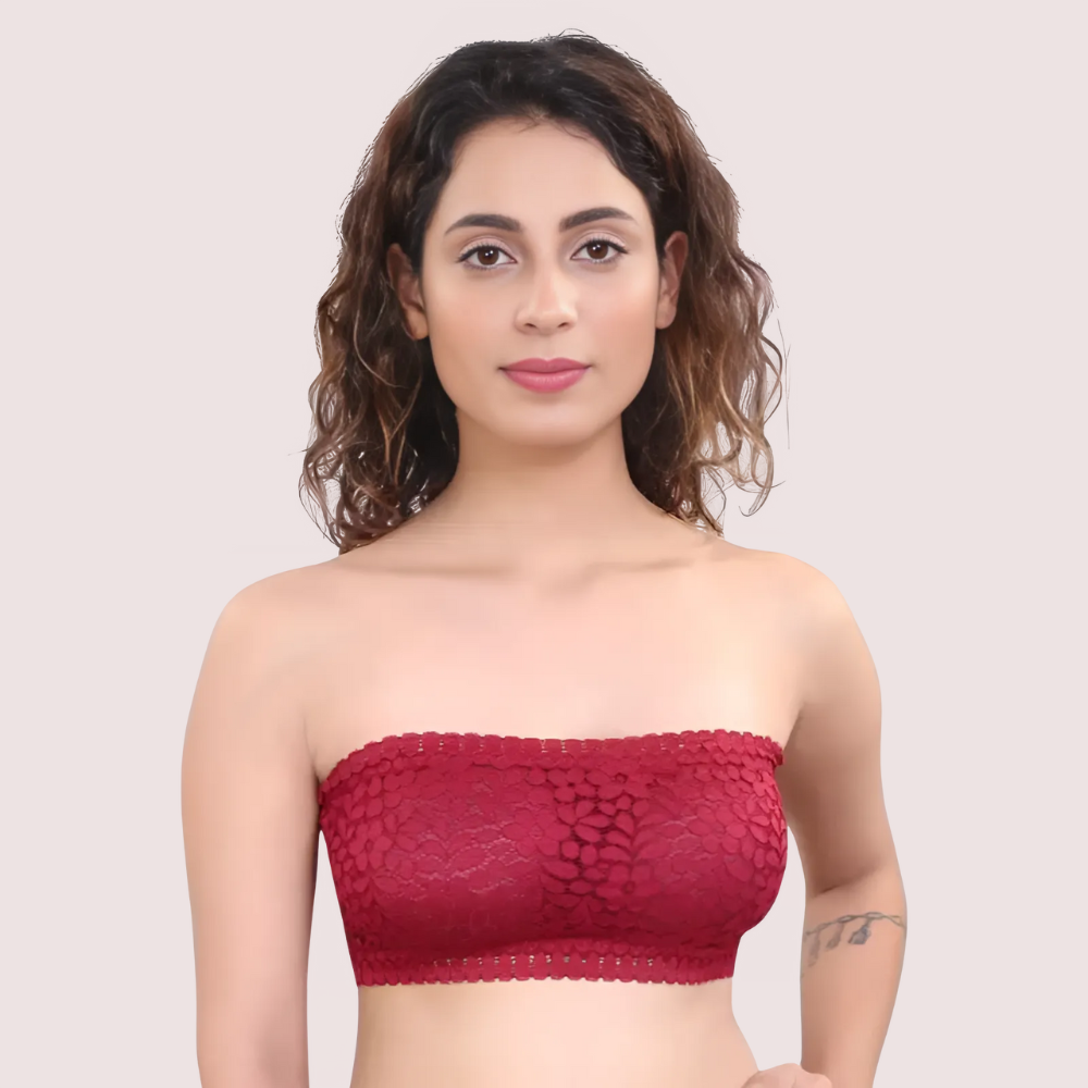 Woman wearing a red strapless top against a plain background