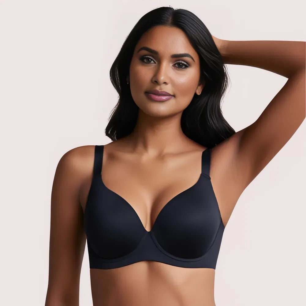 Woman wearing a black bra against a beige background