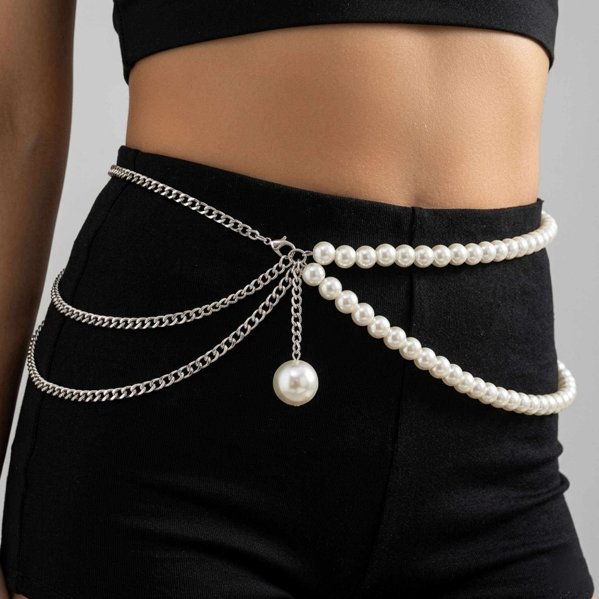 Pearl and chain belt accessory on a black outfit