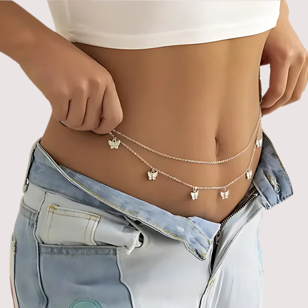 Person wearing a delicate chain necklace with small pendants 