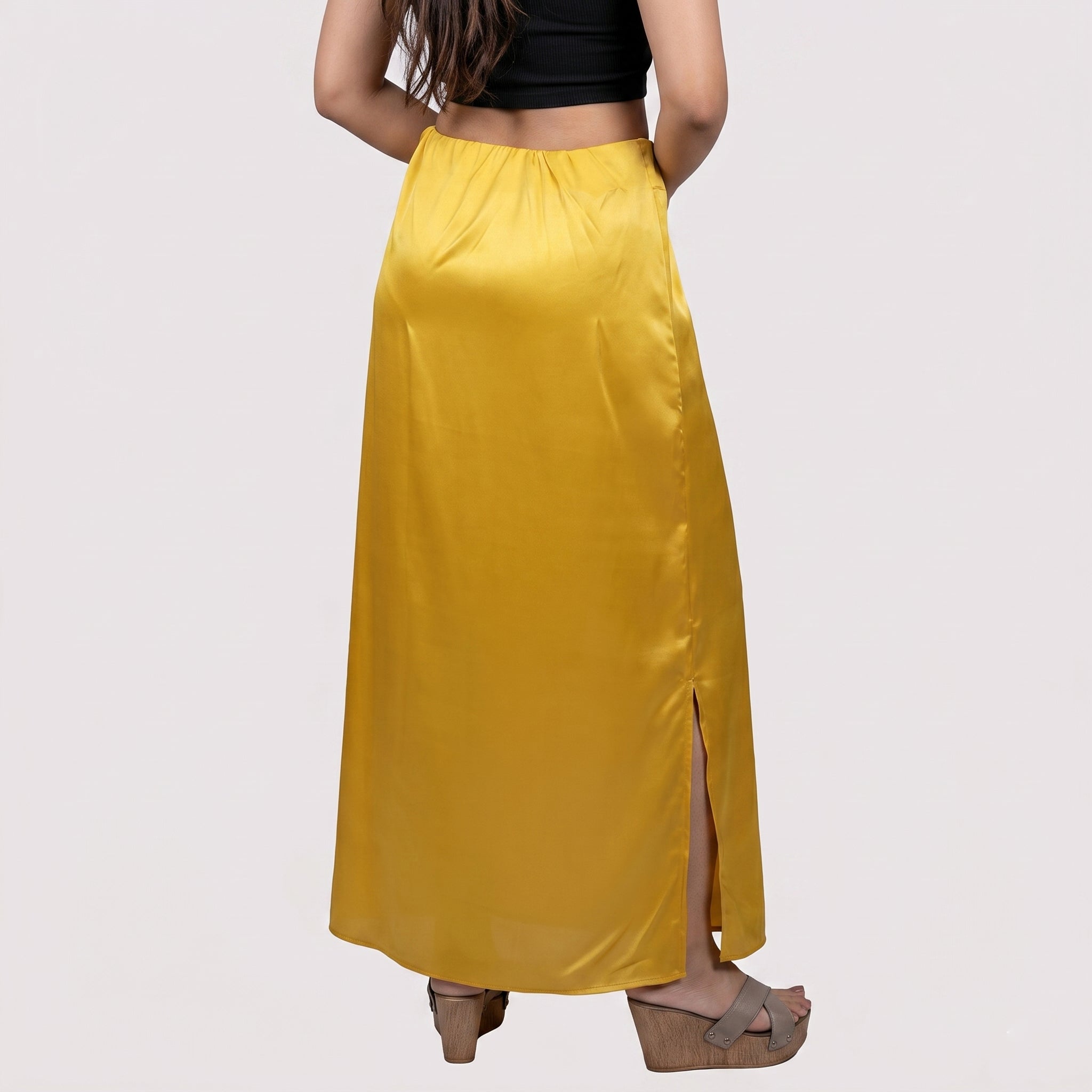 Person wearing a yellow satin skirt