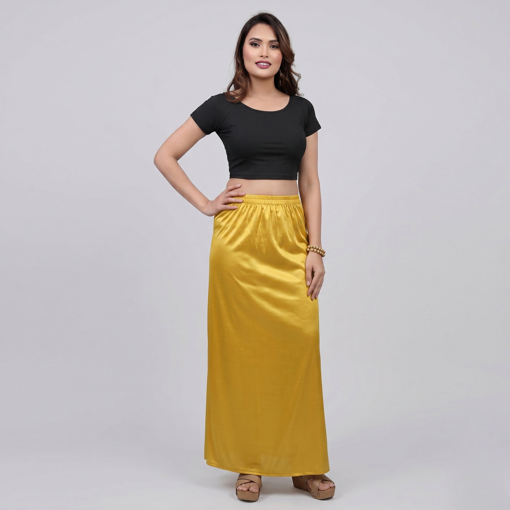 Woman wearing a black top and yellow shapewear 