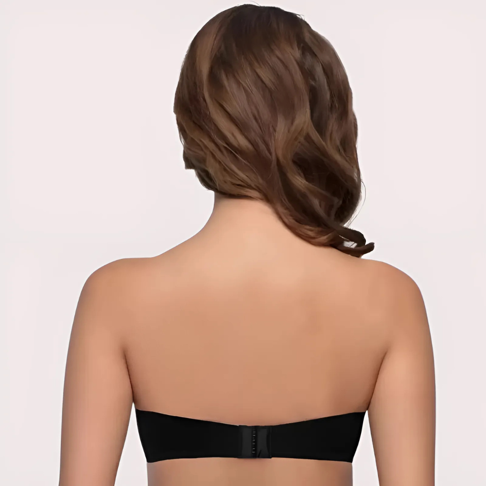 Black strapless bra worn by a model on a plain background