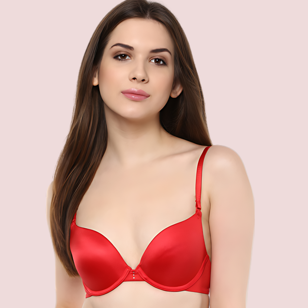 Woman wearing a red bra against a pink background