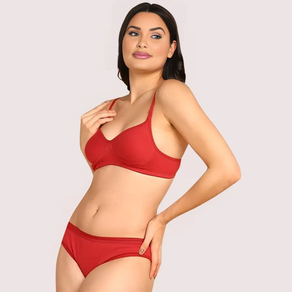 Woman wearing a red bikini set on a plain background