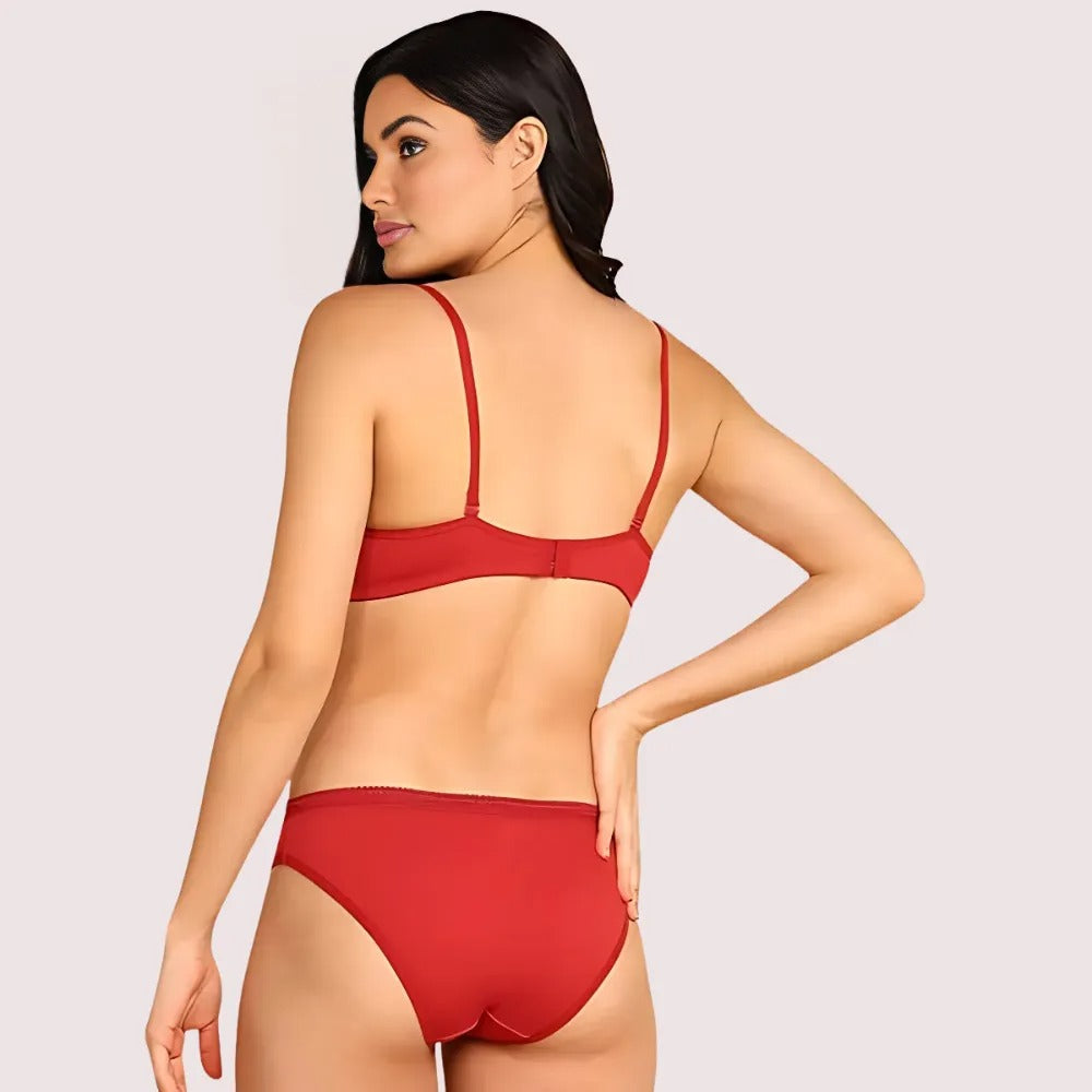 Woman wearing a red bikini on a plain background