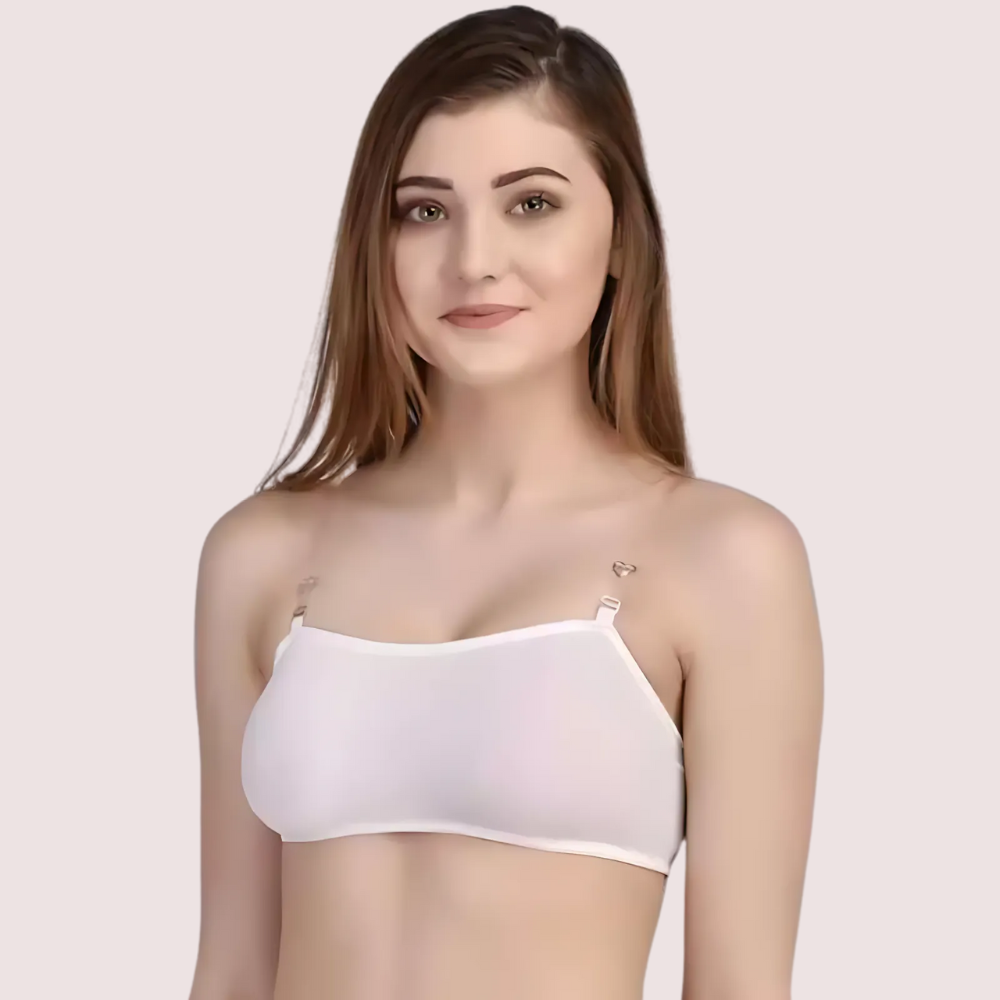 Woman wearing a white strapless top against a plain background
