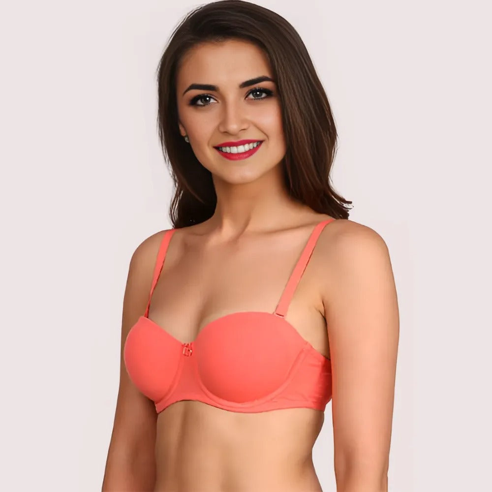 Woman wearing a coral bra against a plain background