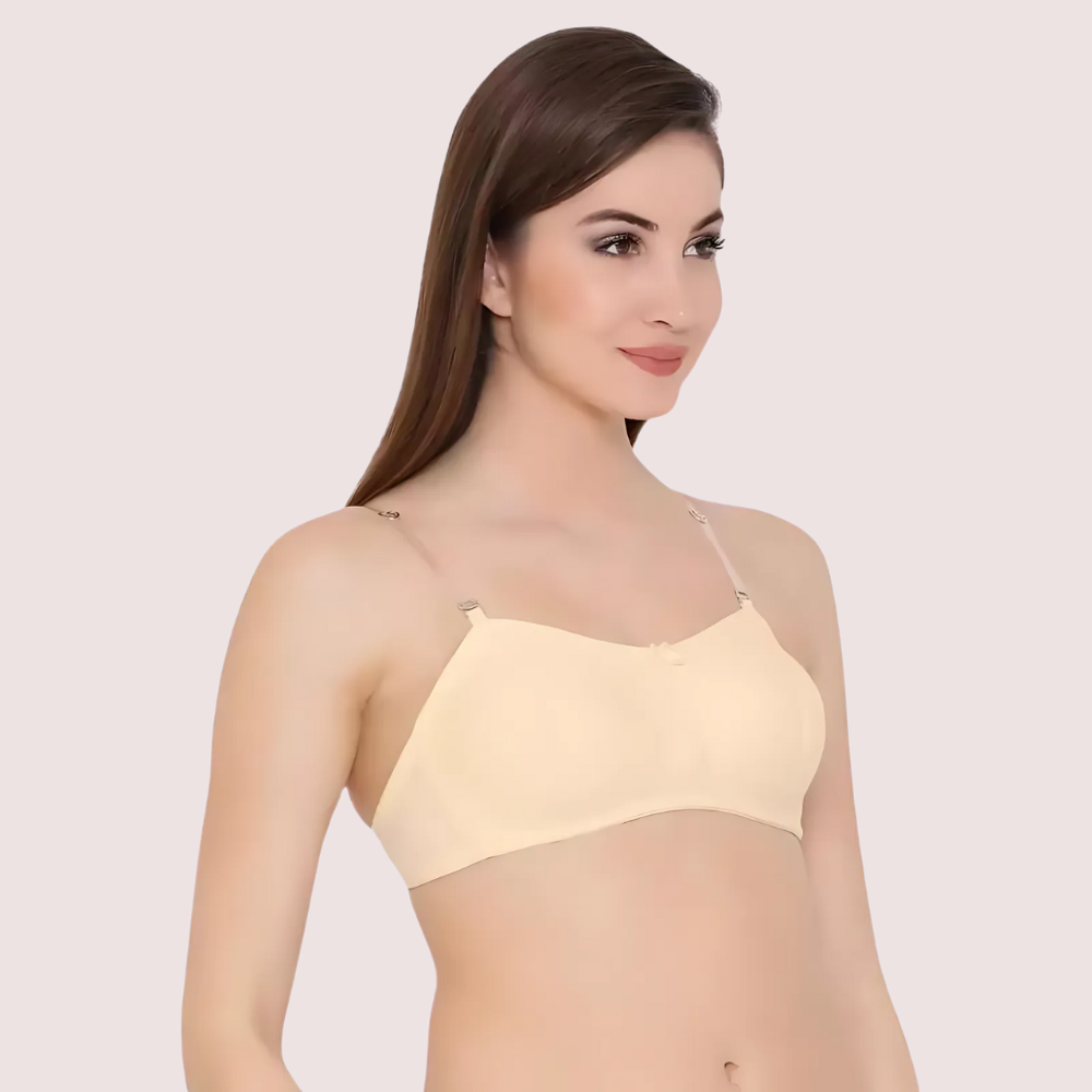 Woman wearing a light yellow bralette against a plain background