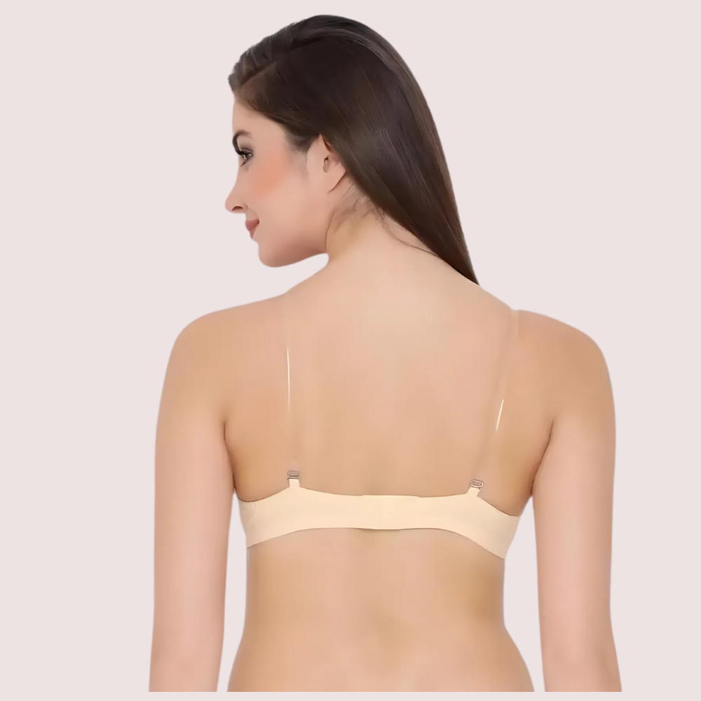 Woman wearing a beige bra on a plain background